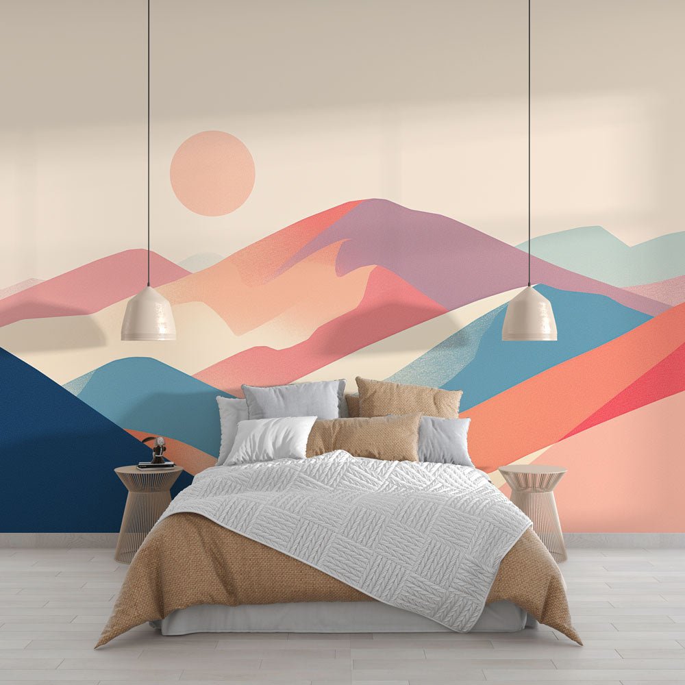 Mountain mural wallpaper with abstract pastel sunset design shown in modern bedroom setting