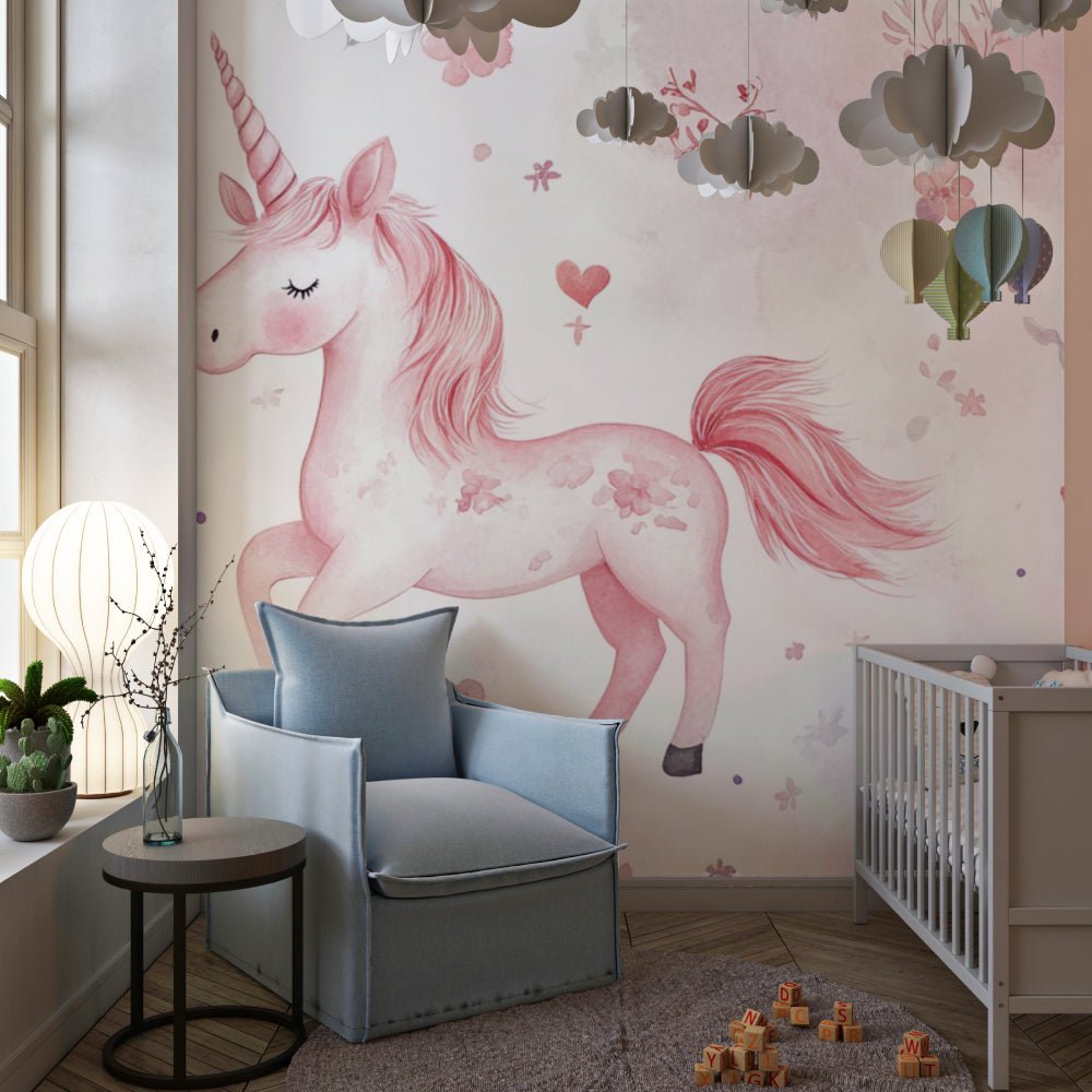 Pink unicorn mural wallpaper in nursery setting with gray armchair and cloud decorations