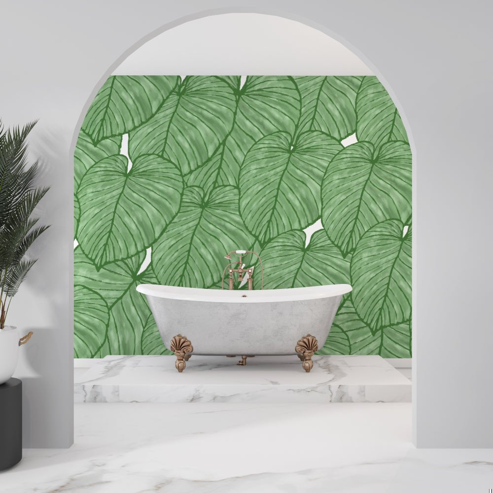 Elegant clawfoot bathtub with tropical Monstera leaf mural wallpaper backdrop