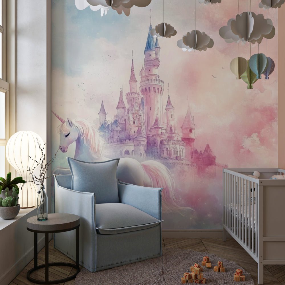 Magical unicorn wall mural with fairy castle in nursery setting with paper cloud decorations