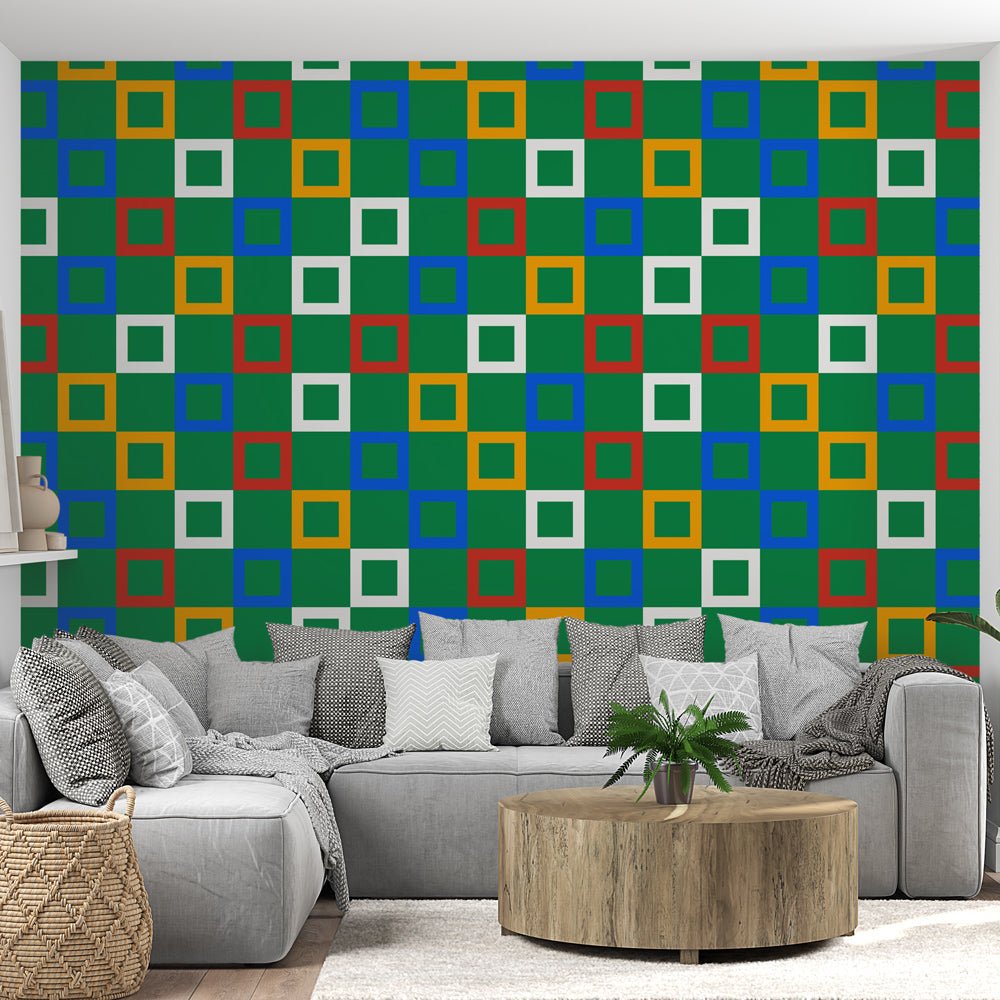 Modern geometric mural wallpaper with multicolored squares pattern on green background shown in contemporary living room setting
