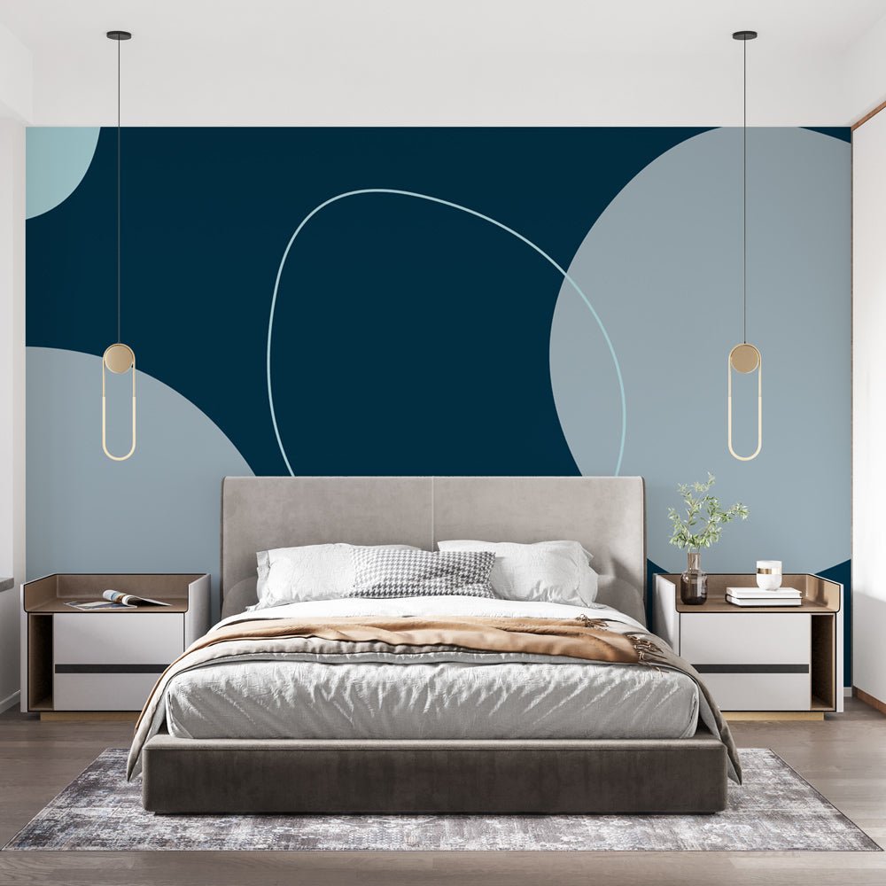 Modern abstract geometric mural wallpaper with navy blue and gray circles in contemporary bedroom setting