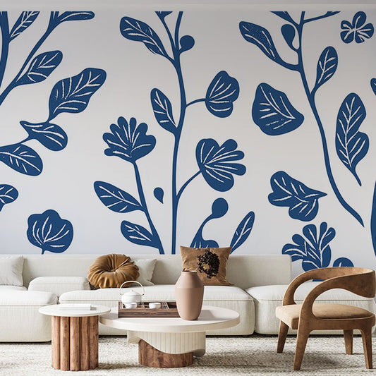 Modern botanical mural wallpaper with navy blue leaves pattern in contemporary living room setting