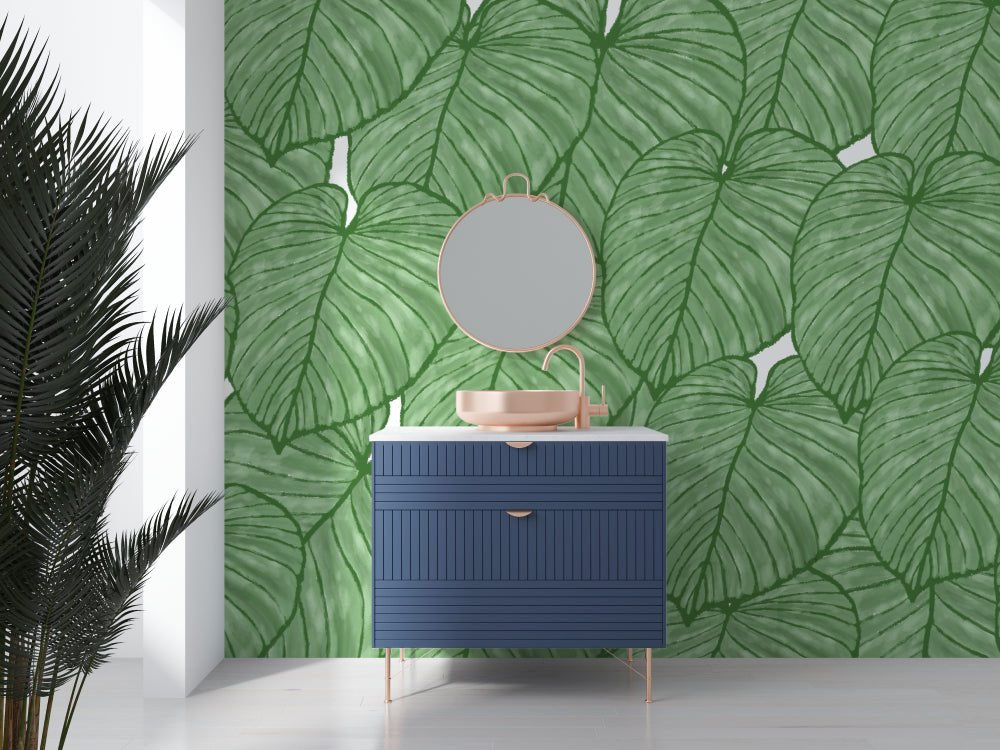 Modern bathroom vanity against XXL Monstera leaf mural wallpaper in natural green