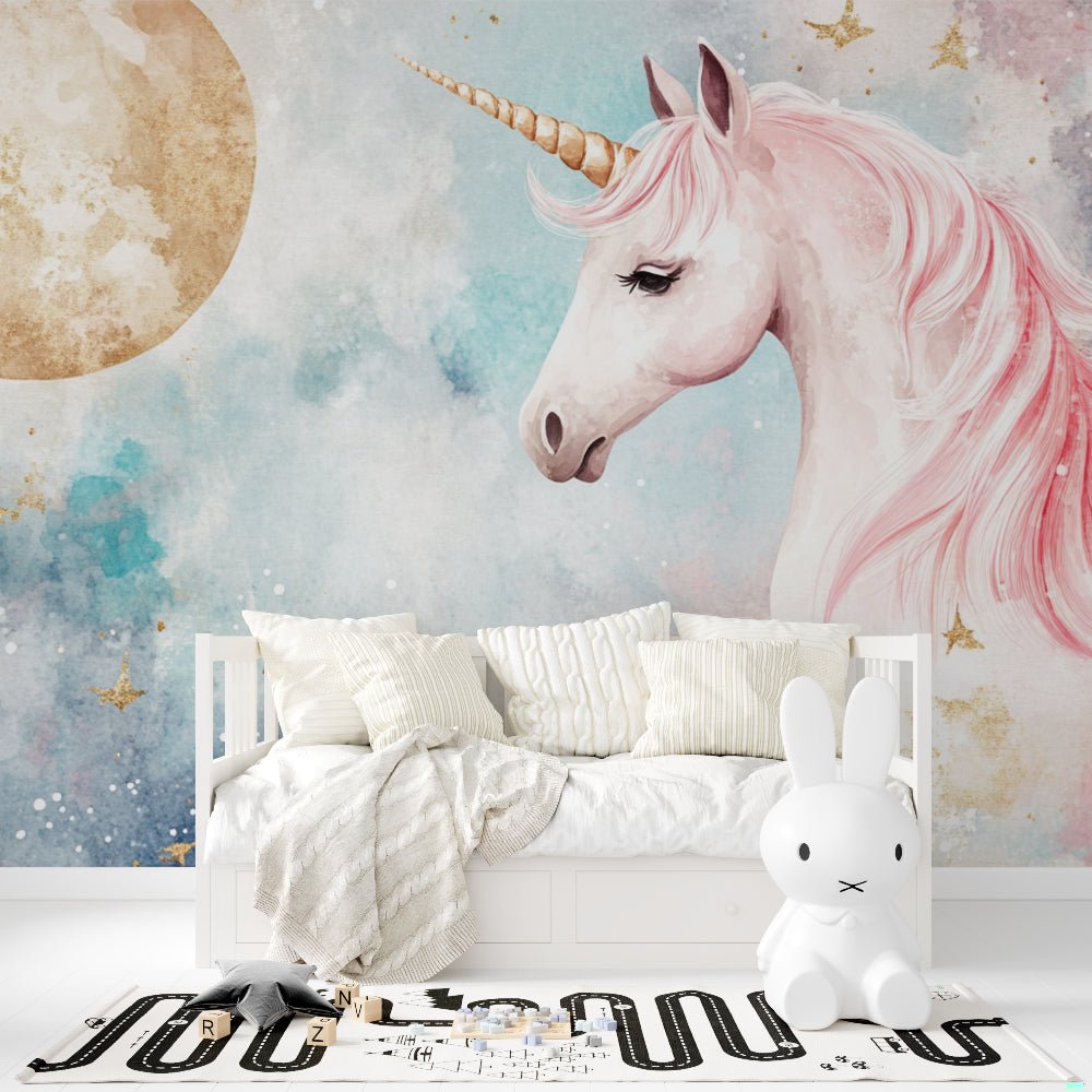 Unicorn wall mural with pink mane and golden accents, displayed in children's room with white furniture
