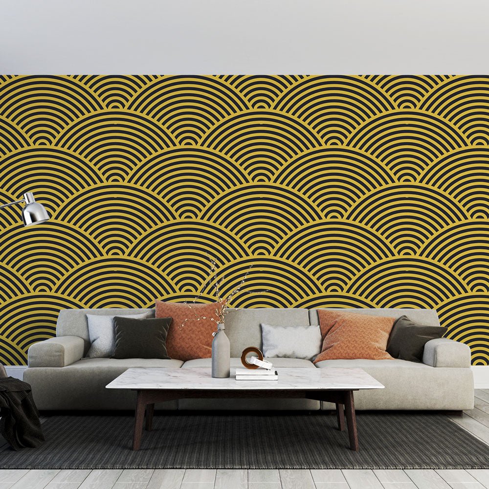Art Deco geometric golden waves mural wallpaper in a modern living room setting with grey sofa and marble coffee table
