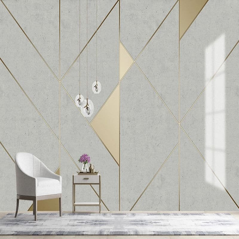 Geometric mural wallpaper with gold accents displayed in minimalist room setting
