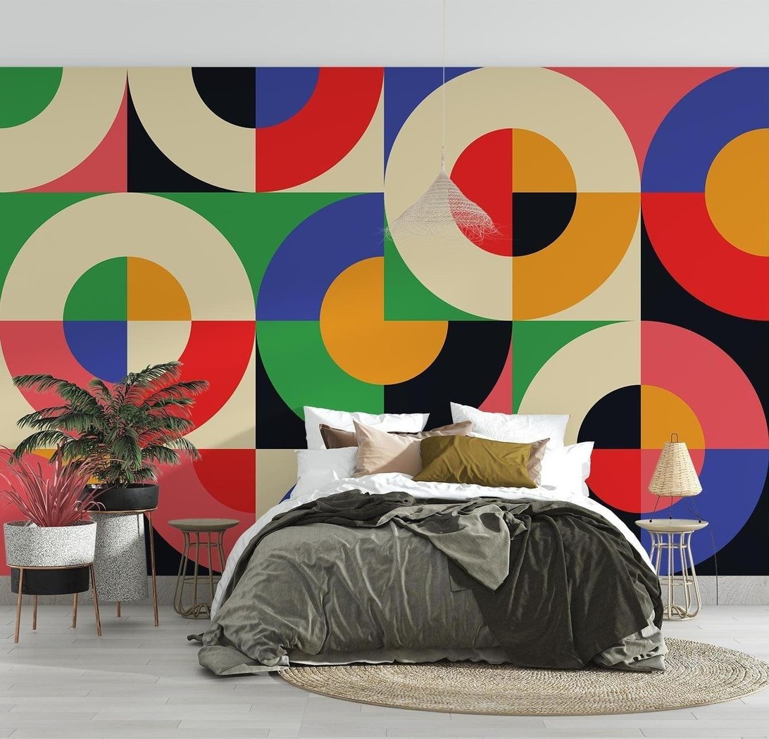Bauhaus geometric mural wallpaper with multicolored circles in modern bedroom setting