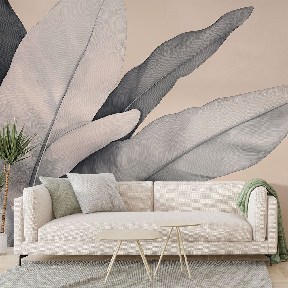 Modern botanical mural wallpaper with large gray and beige leaves in a contemporary living room setting