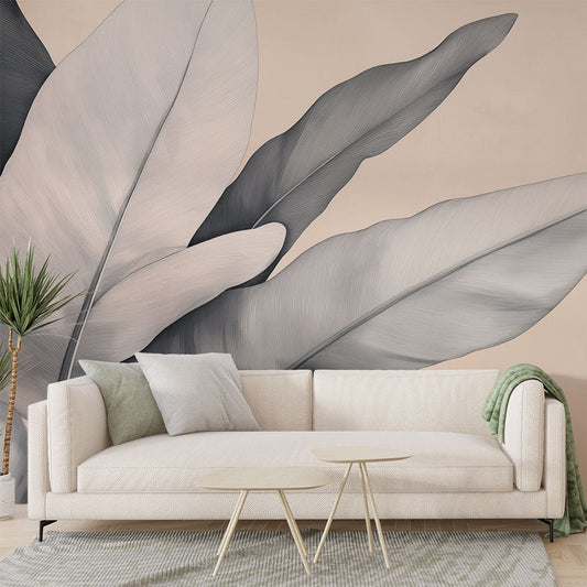 Modern botanical mural wallpaper with large gray and beige leaves in a contemporary living room setting
