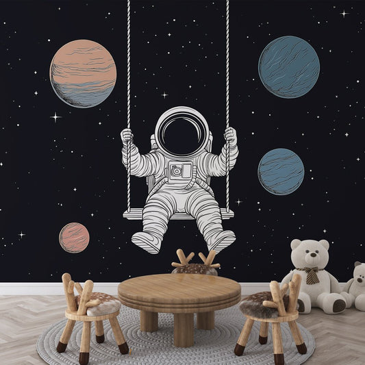 Astronaut on swing mural wallpaper with floating planets in nursery setting