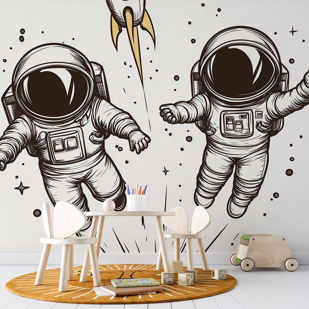 Black and white astronaut mural wallpaper with golden rocket in children's room setting