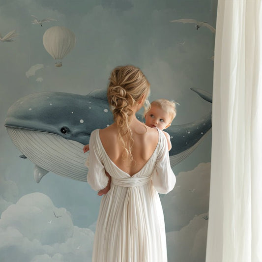 Whimsical whale mural wallpaper in a nursery setting with floating hot air balloons
