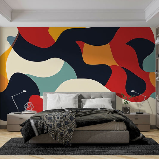 Modern abstract mural wallpaper with fluid shapes in navy, red, and orange shown in contemporary bedroom setting