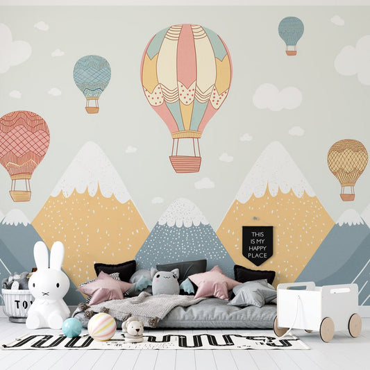 Hot air balloon mural wallpaper in pastel colors with mountain landscape, shown in a modern children's room setting