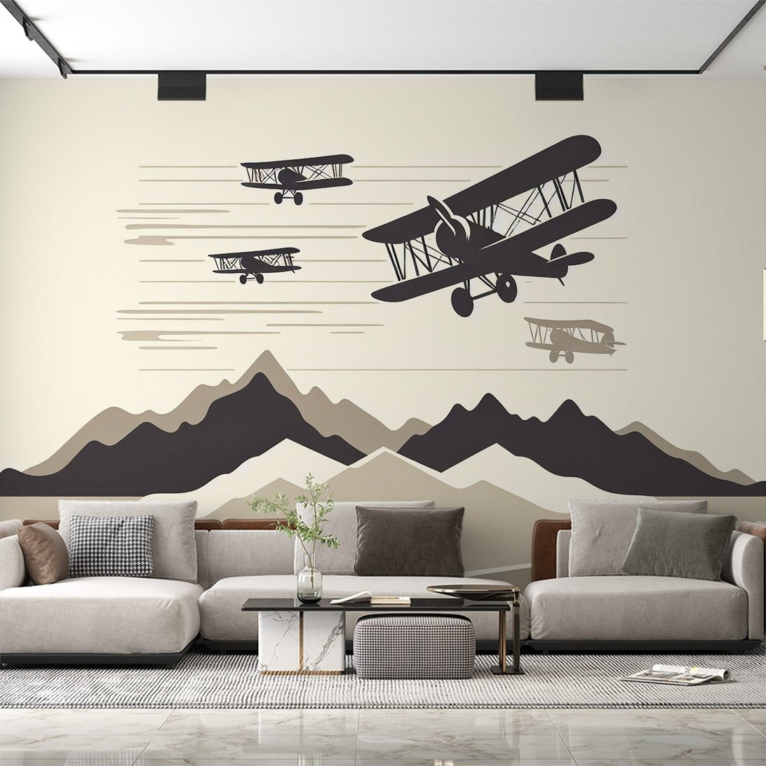 Vintage aviation mural wallpaper with black biplane silhouettes flying over minimalist mountain landscape in living room setting