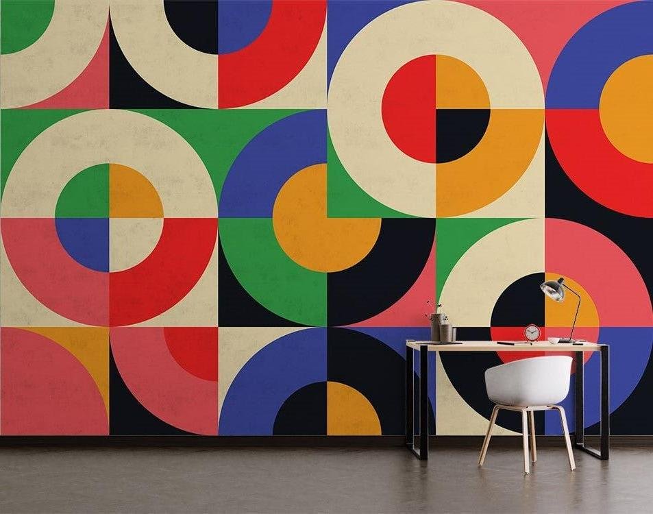Bauhaus-inspired geometric wallpaper with colorful circles in home office setting