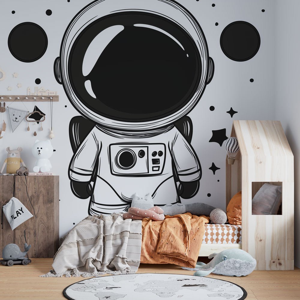 Black and white astronaut mural wallpaper in a modern children's bedroom with space-themed decor