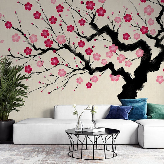 Japanese cherry blossom mural wallpaper with pink sakura flowers on black branches, shown in modern living room setting