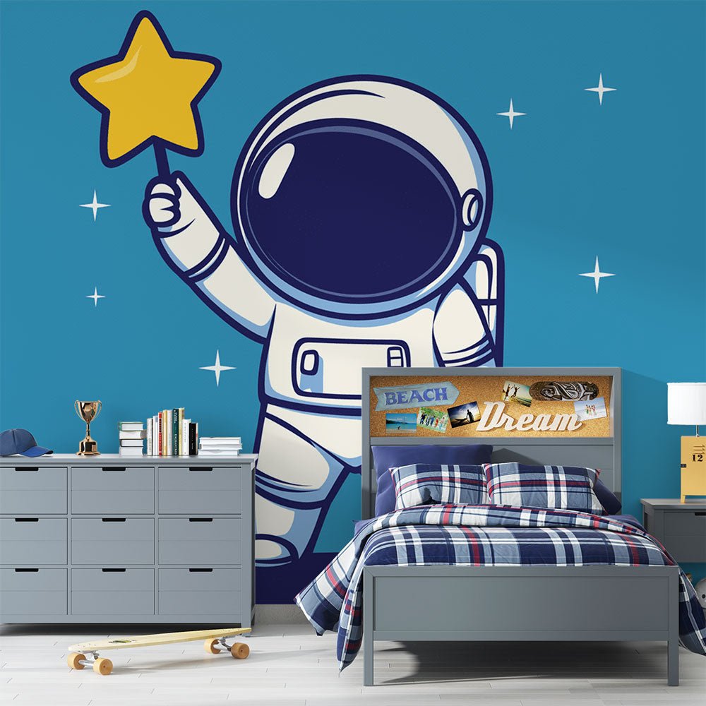 Astronaut mural wallpaper with cute spaceman reaching for golden star, shown in modern kids bedroom setting