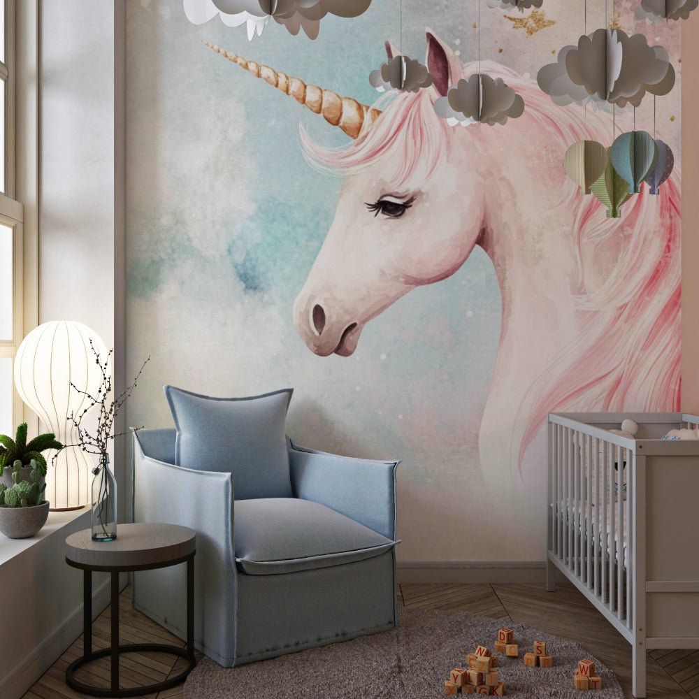 Dreamy unicorn mural wallpaper with decorative paper clouds and modern nursery furniture
