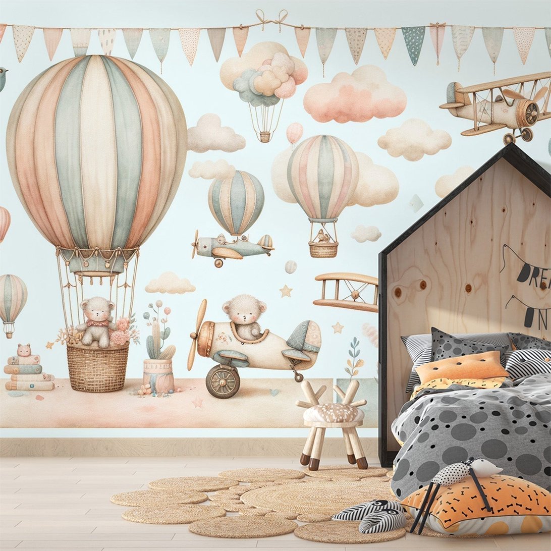 Hot air balloon nursery mural wallpaper with teddy bears and vintage aircraft in soft pastel colors