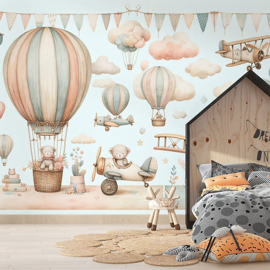 Hot air balloon nursery mural wallpaper with teddy bears and vintage aircraft in soft pastel colors