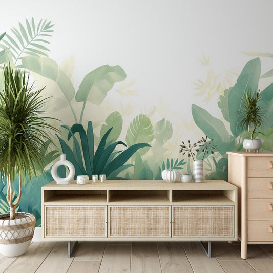 Tropical jungle mural wallpaper in sage green watercolor design shown in modern living room setting with rattan furniture